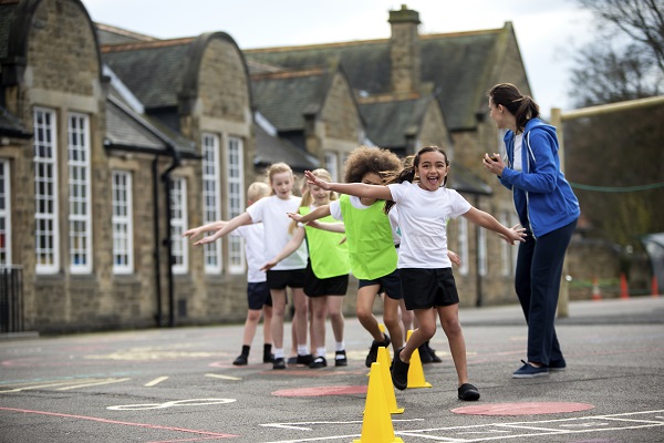 Image of children doing exercise in a school playground